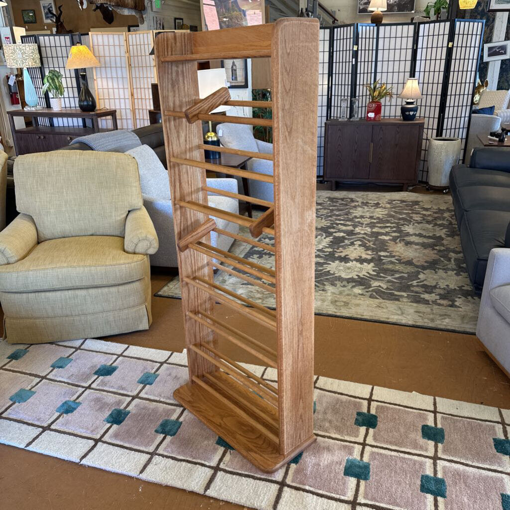 Wooden bookshelf in a living room setting with furniture and decor.