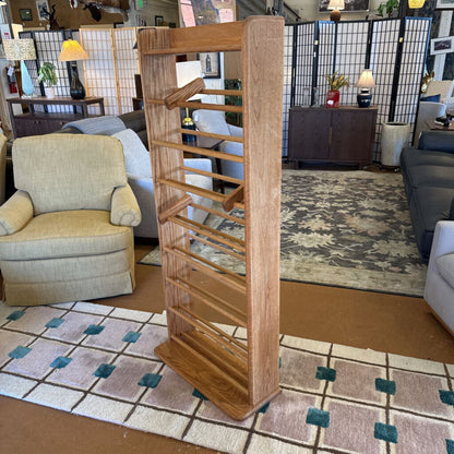 Wooden bookshelf in a living room setting with furniture and decor.