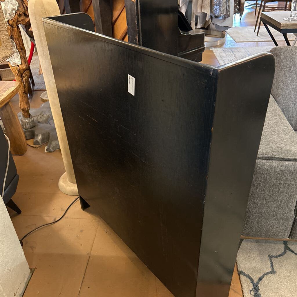 Black metal reception desk in a furniture store setting