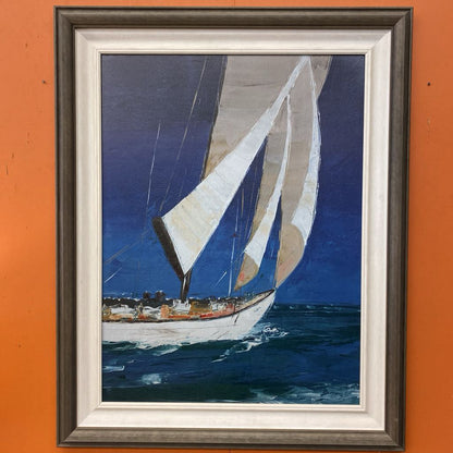 Framed painting of a sailboat on an orange wall