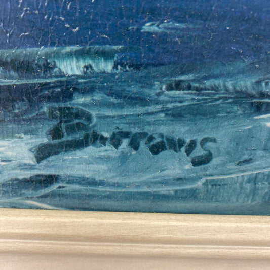 Close-up of a signature on a textured blue and beige surface