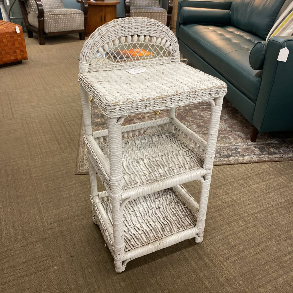 White wicker side table in a room with furniture