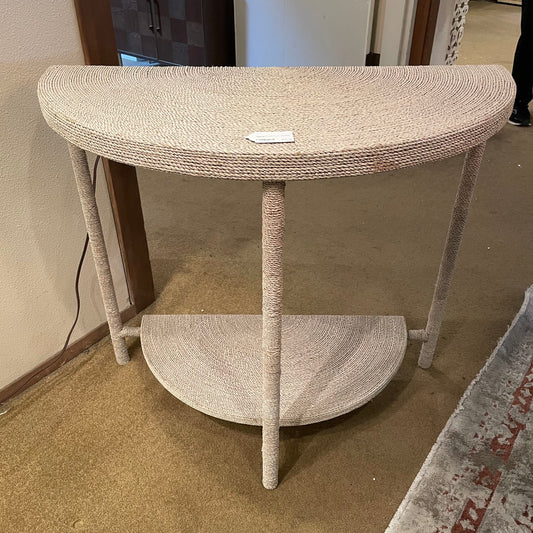 Half-moon cat tree with sisal-wrapped legs and base in a room setting.