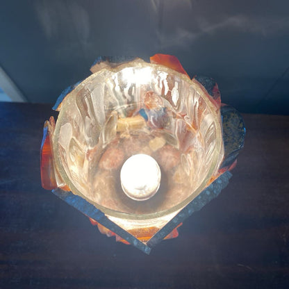 Ceiling light fixture with glass cover on a dark background