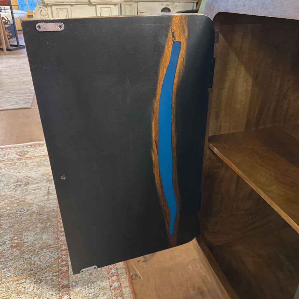 Black book with a blue ribbon on a wooden shelf