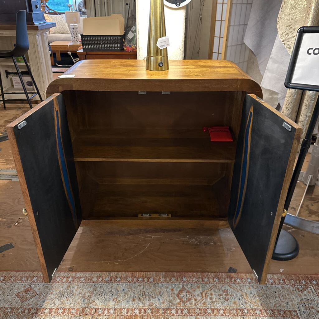 Wooden cabinet with open doors on a wooden floor