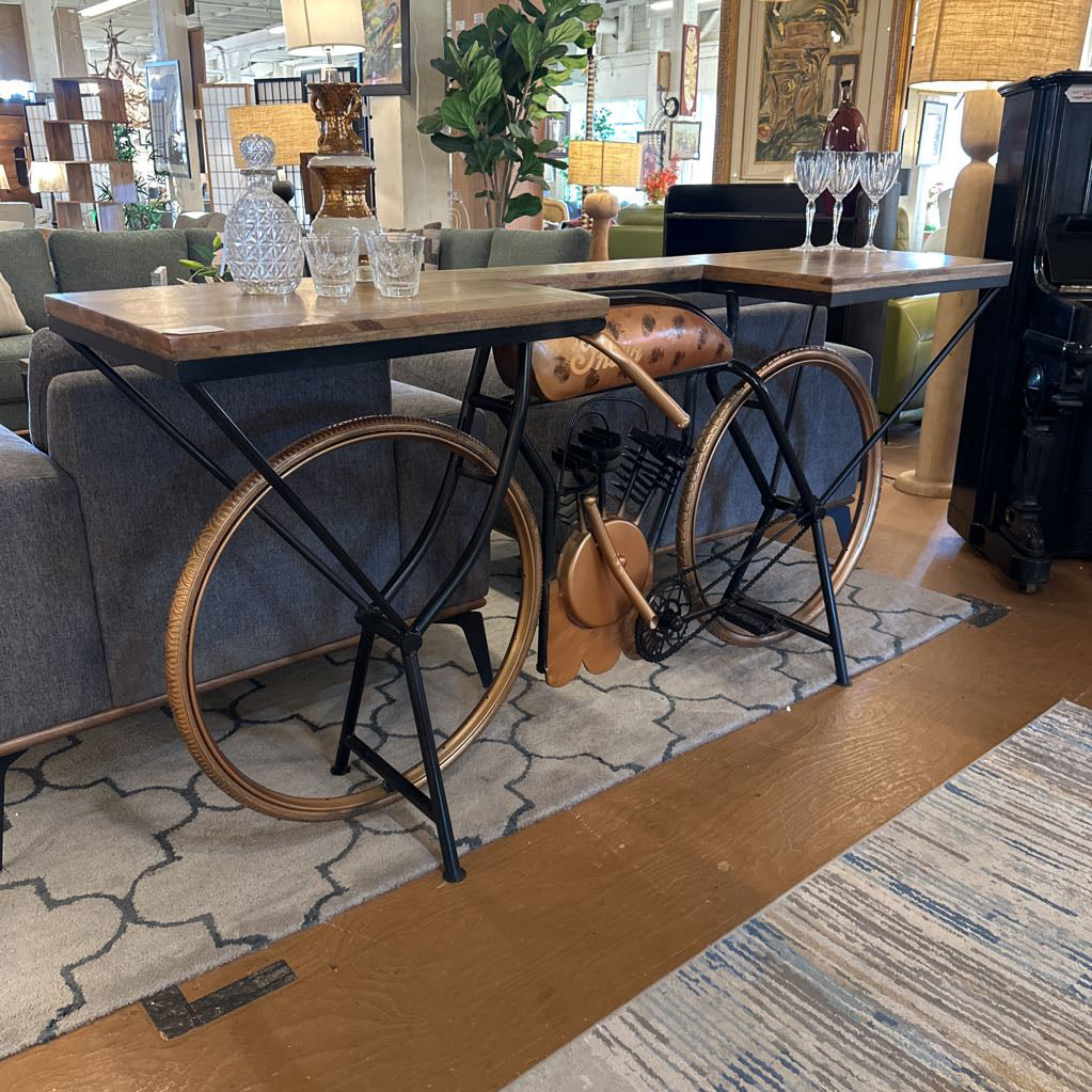 Table with bicycle wheel legs in a room with furniture and decor