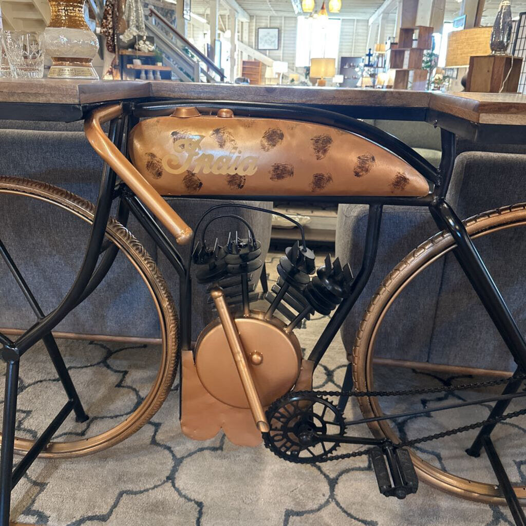Bicycle-style chair with leather seat and handlebar in a room setting