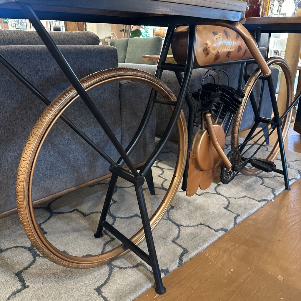Decorative chair with large wooden wheel in a room with furniture and decor.
