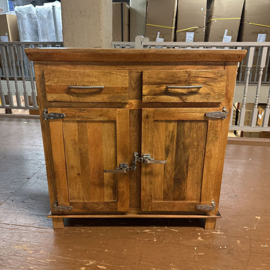 Wooden cabinet with two doors and two drawers in a warehouse setting