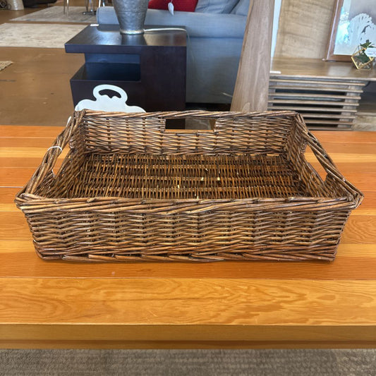 Wicker basket on a wooden table in a living room setting