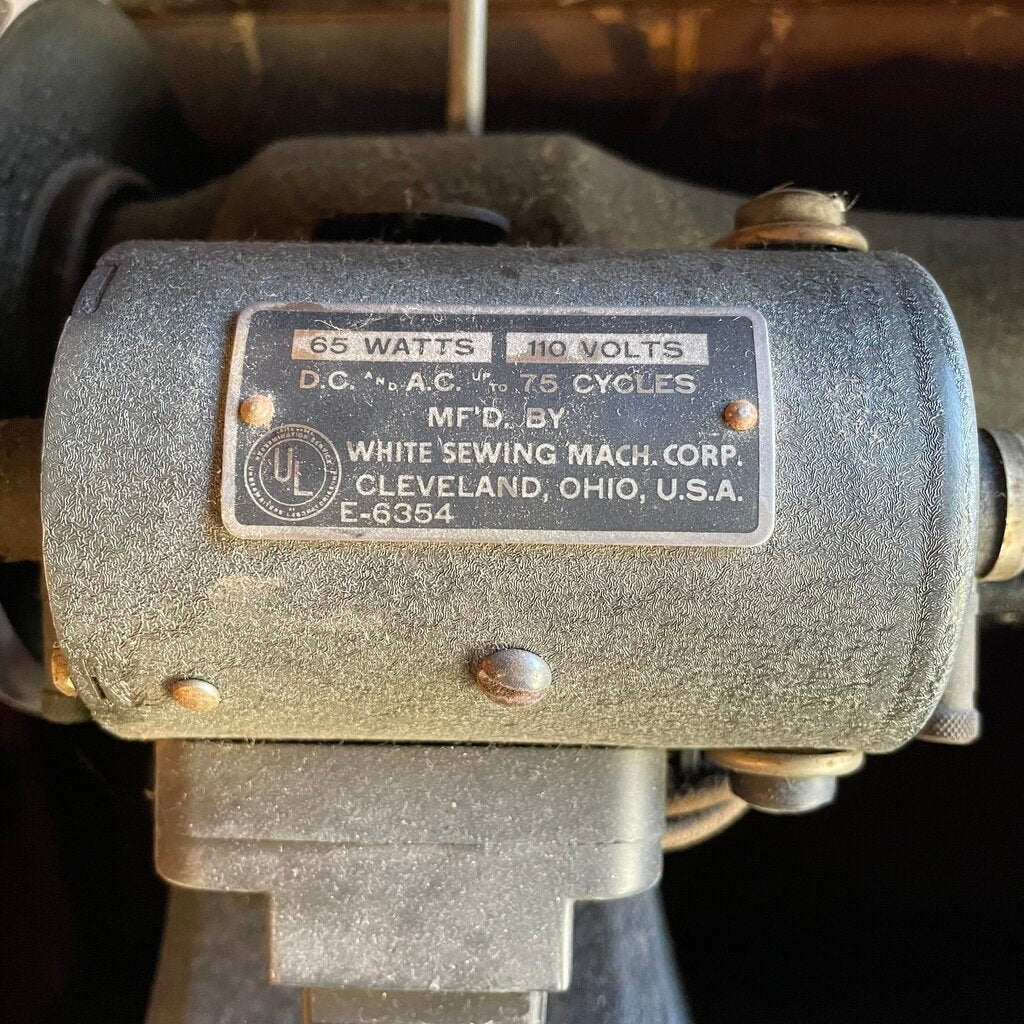 Motor with label indicating specifications and manufacturer details on a dark background