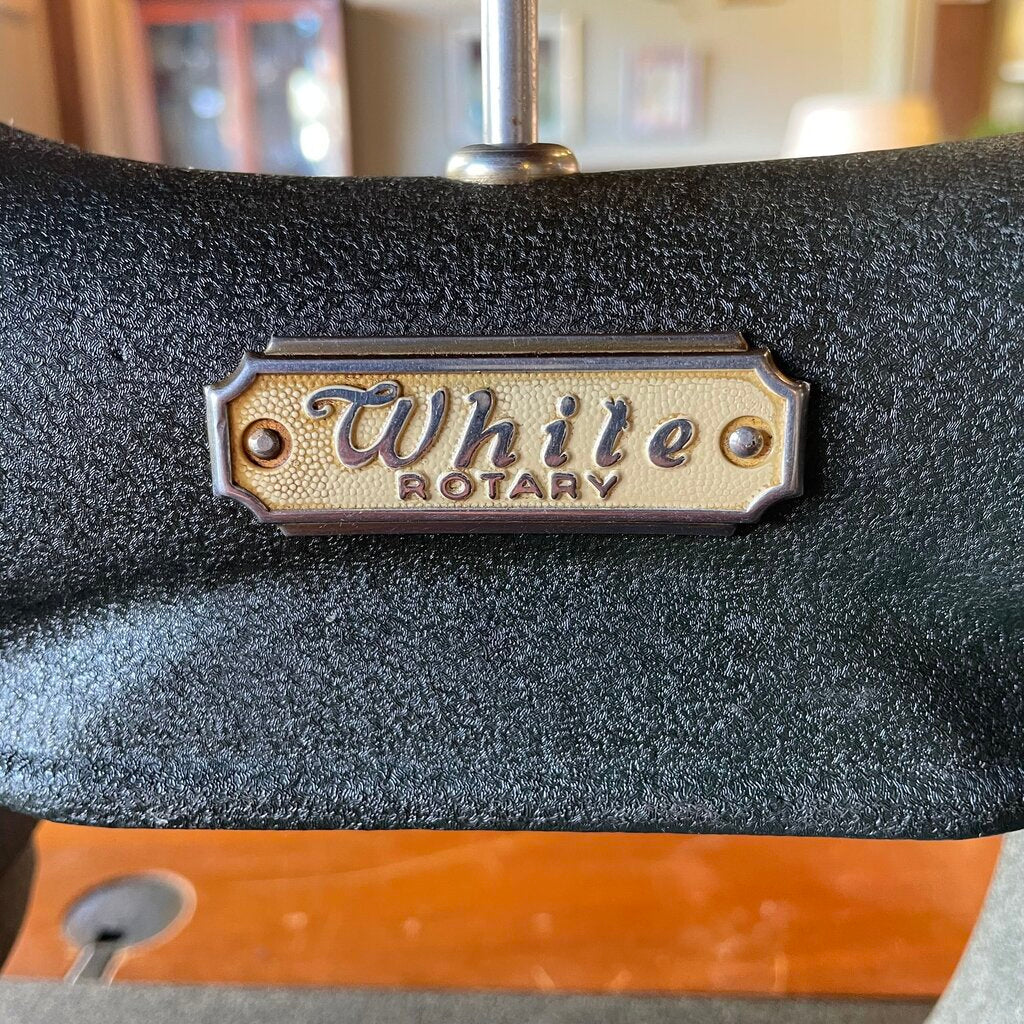 Close-up of a 'White Rotary' label on a textured surface with a blurred background.