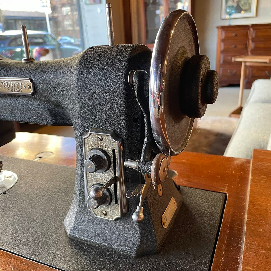 Close-up of an old-fashioned sewing machine with a blurred background