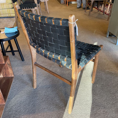 Wooden chair with woven black seat in a room setting