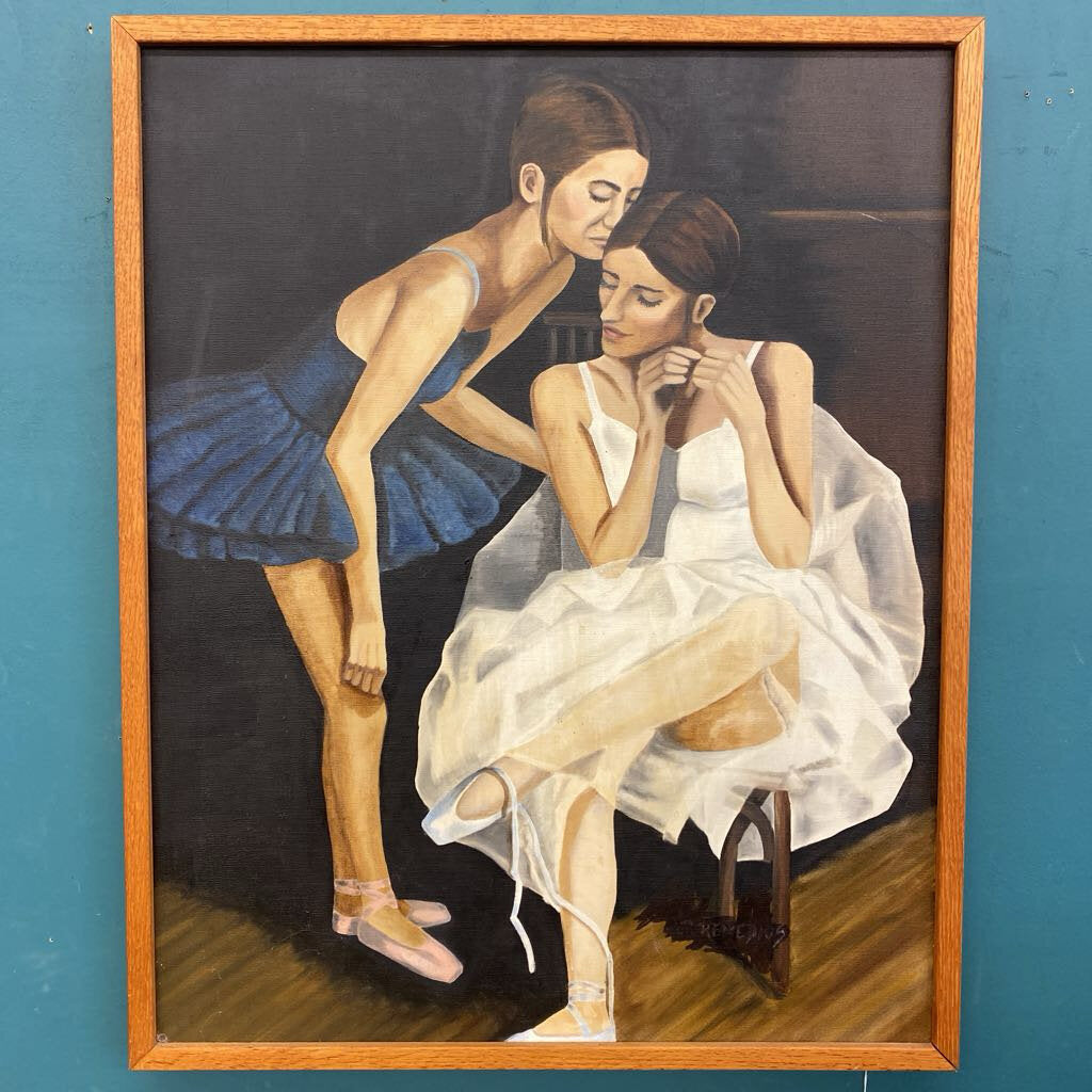 Painting of two women in a wooden frame against a blue wall.