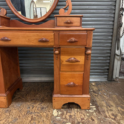 Wooden vanity with mirror against a metal shutter background