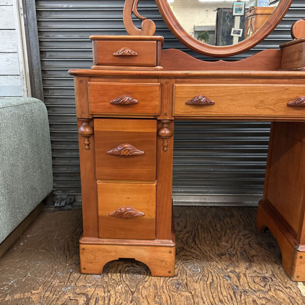 Wooden vanity with mirror on a wooden floor