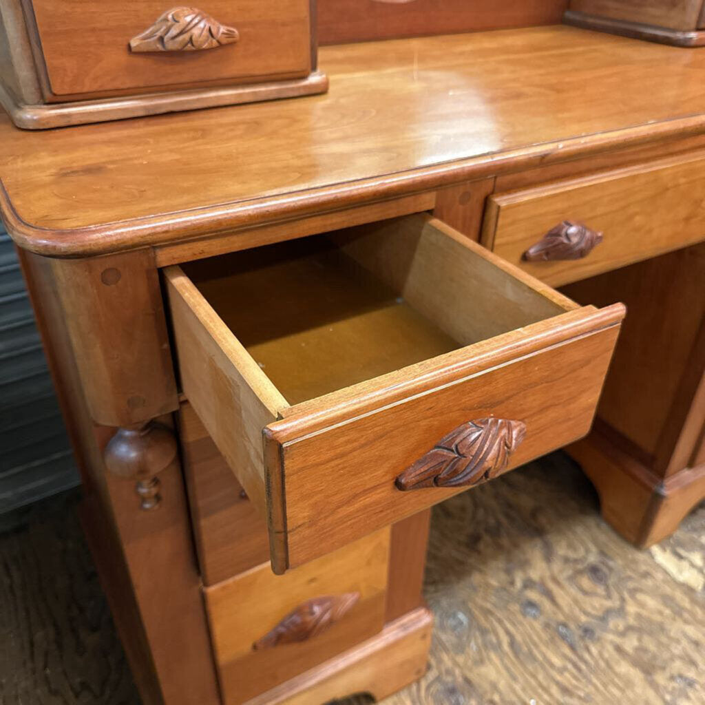 Wooden dresser with open drawer showing a worn interior.