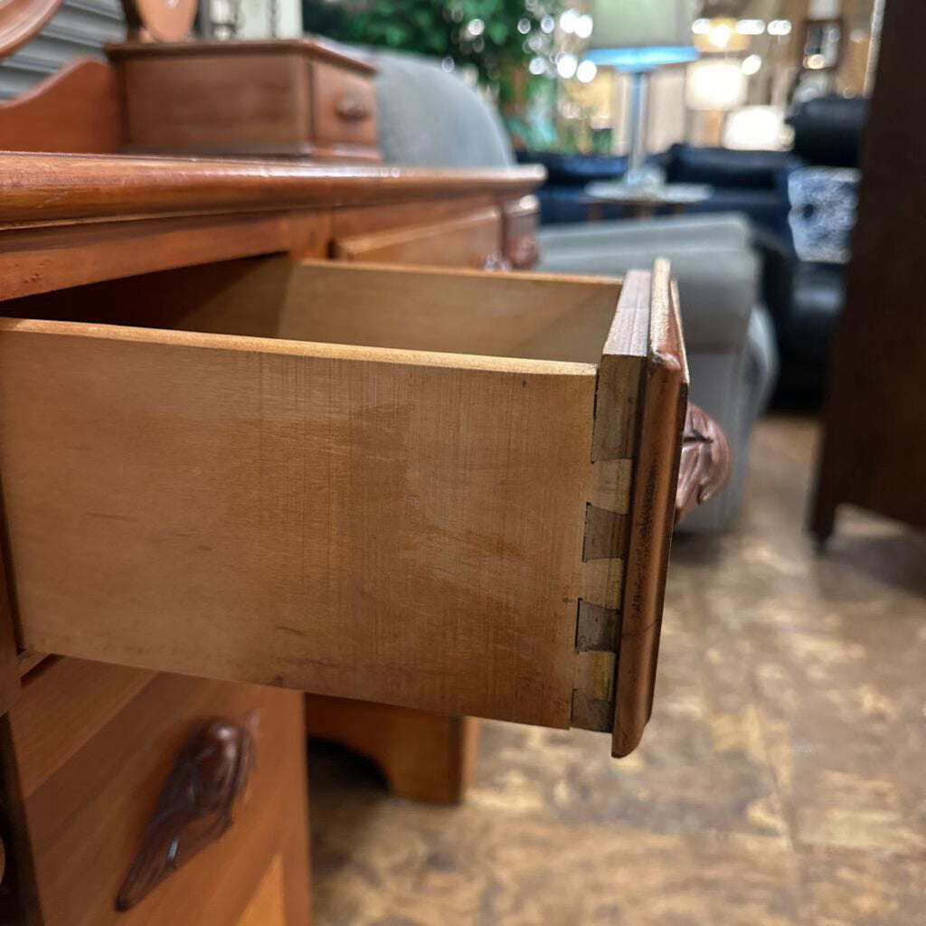 Wooden drawer being pulled out of a wooden cabinet with blurred background