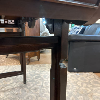 Close-up of a wooden table leg with a blurred background