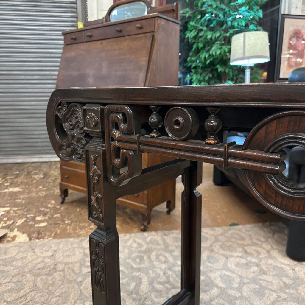 Decorative wooden stand with intricate carvings in an outdoor setting