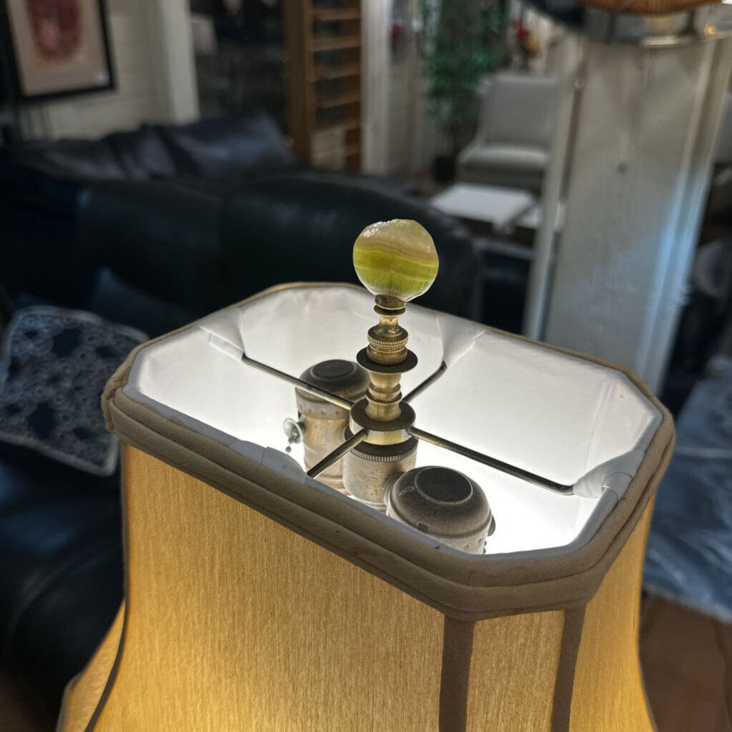 Decorative object with a spherical top on a wooden base in a living room setting
