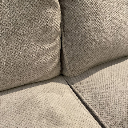 Close-up of a textured beige sofa corner