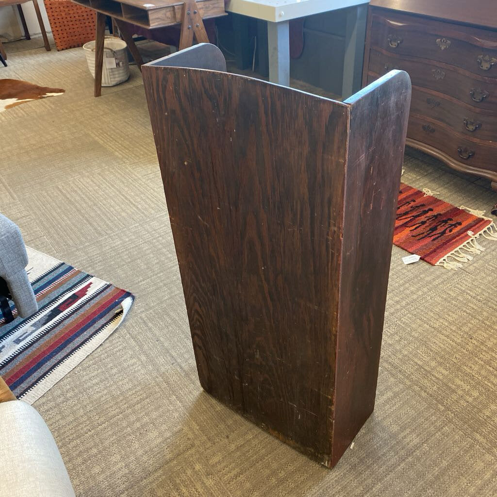 Wooden podium in a room with furniture and a rug on the floor.