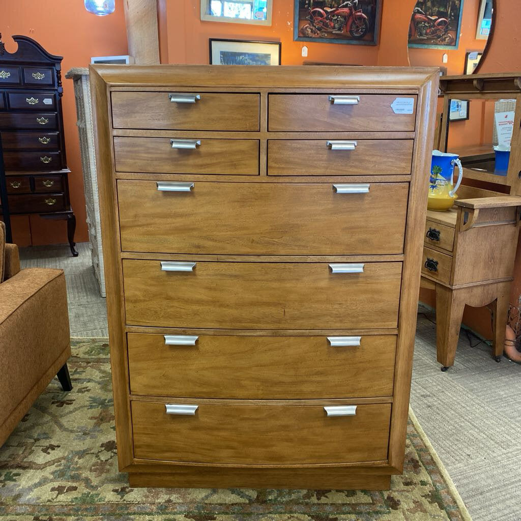 Wooden dresser with multiple drawers in a room setting