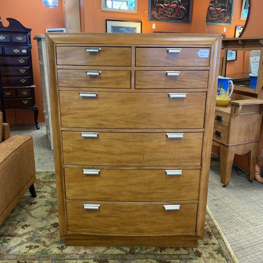 Wooden dresser with multiple drawers in a room setting