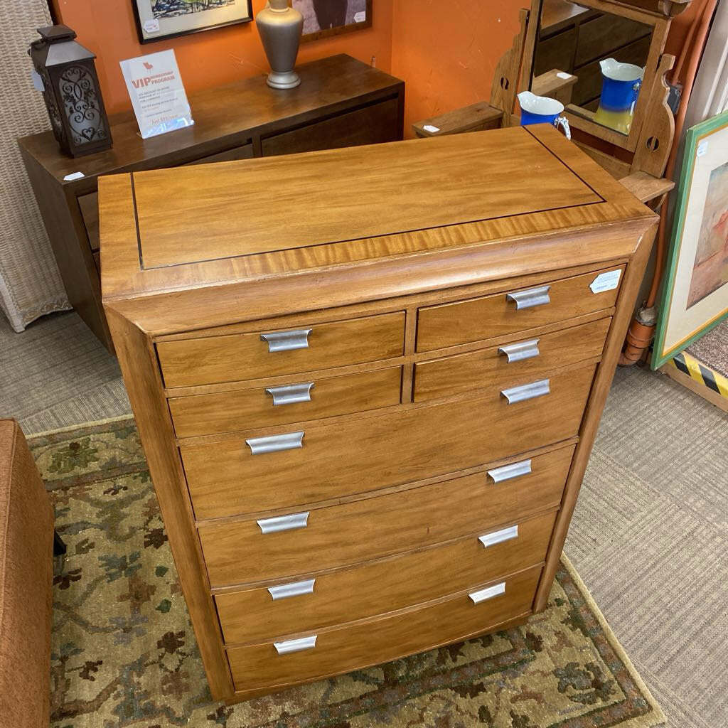 Wooden dresser with multiple drawers in a room setting