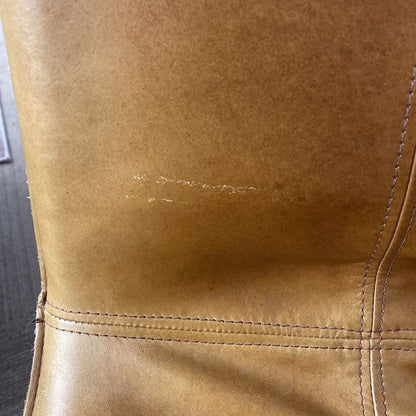 Close-up of a brown leather bag with visible stitching