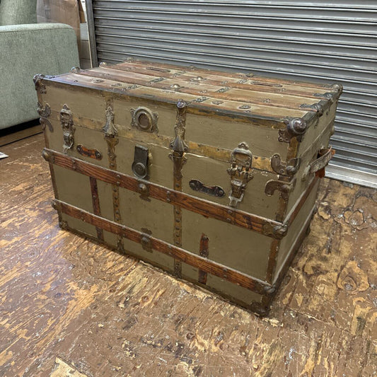 Vintage trunk with metal clasps on a wooden floor