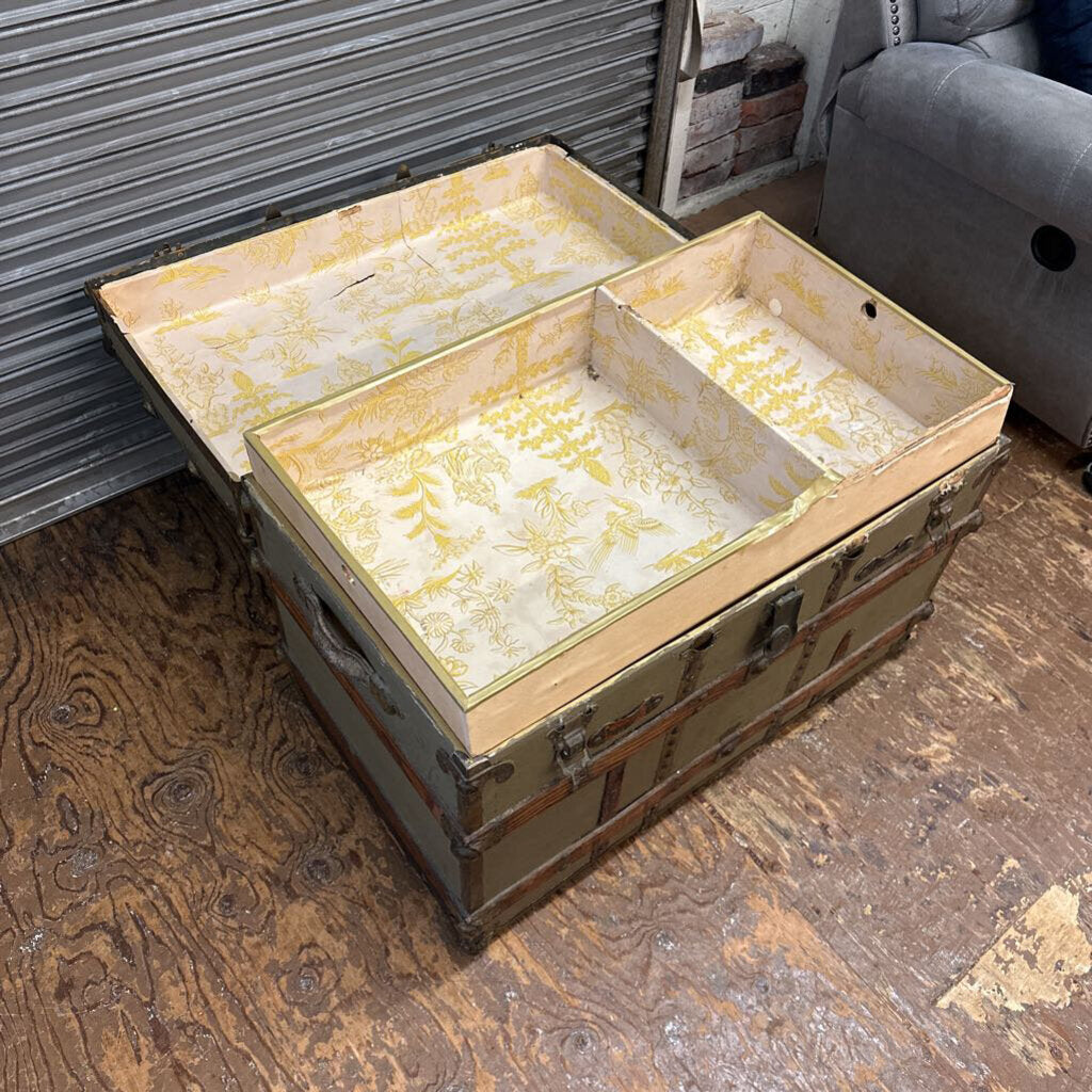 Vintage-style trunk with compartments on a wooden floor