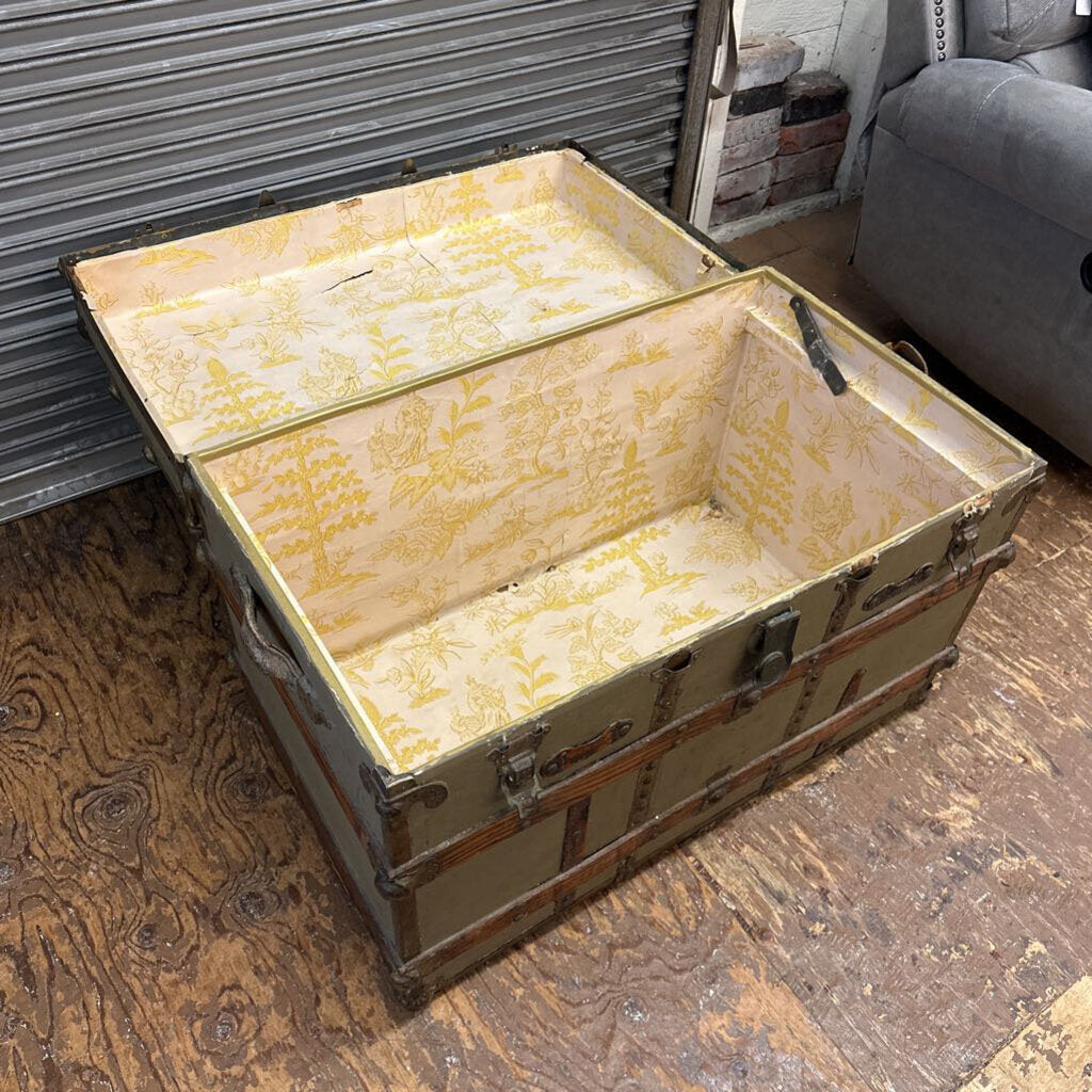Vintage-style trunk with floral pattern on a wooden floor