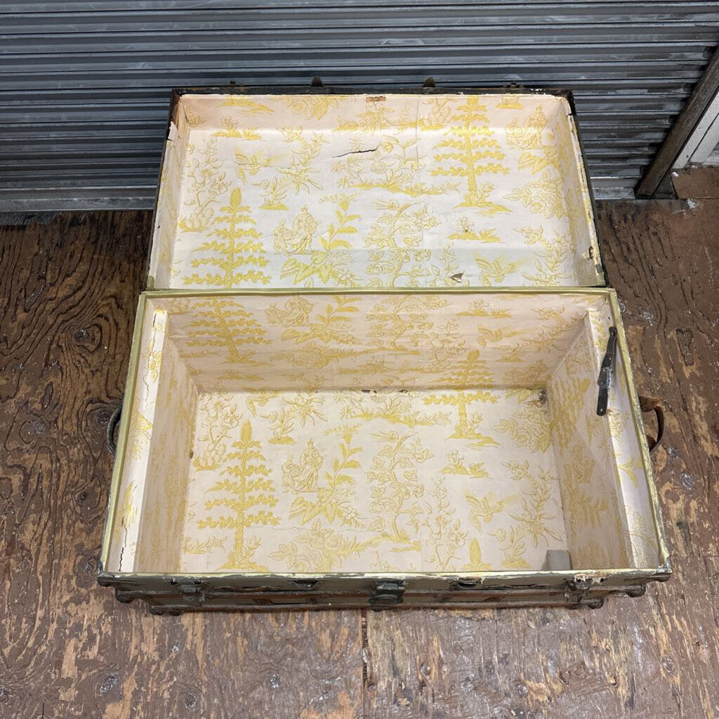 Old wooden crate with yellowed interior on a wooden floor