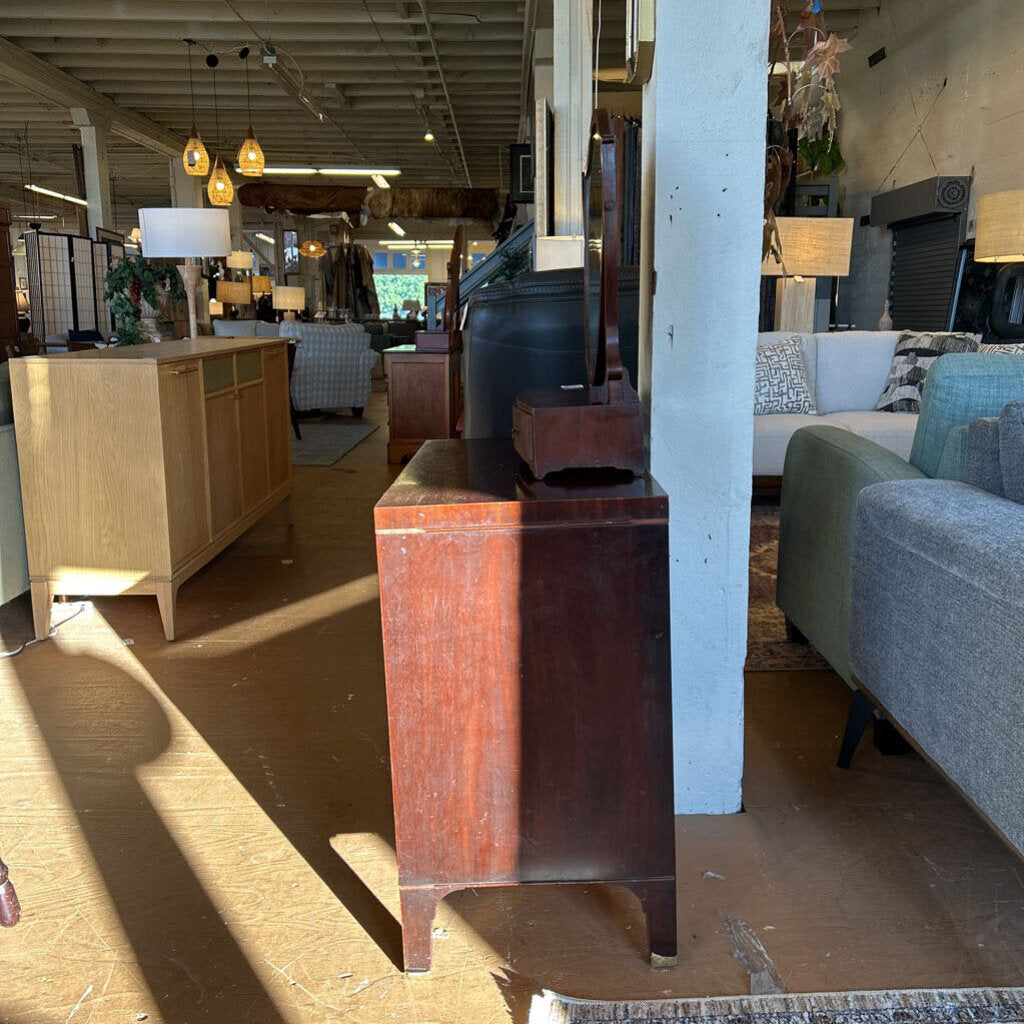 Wooden cabinet in a furniture store with various items in the background