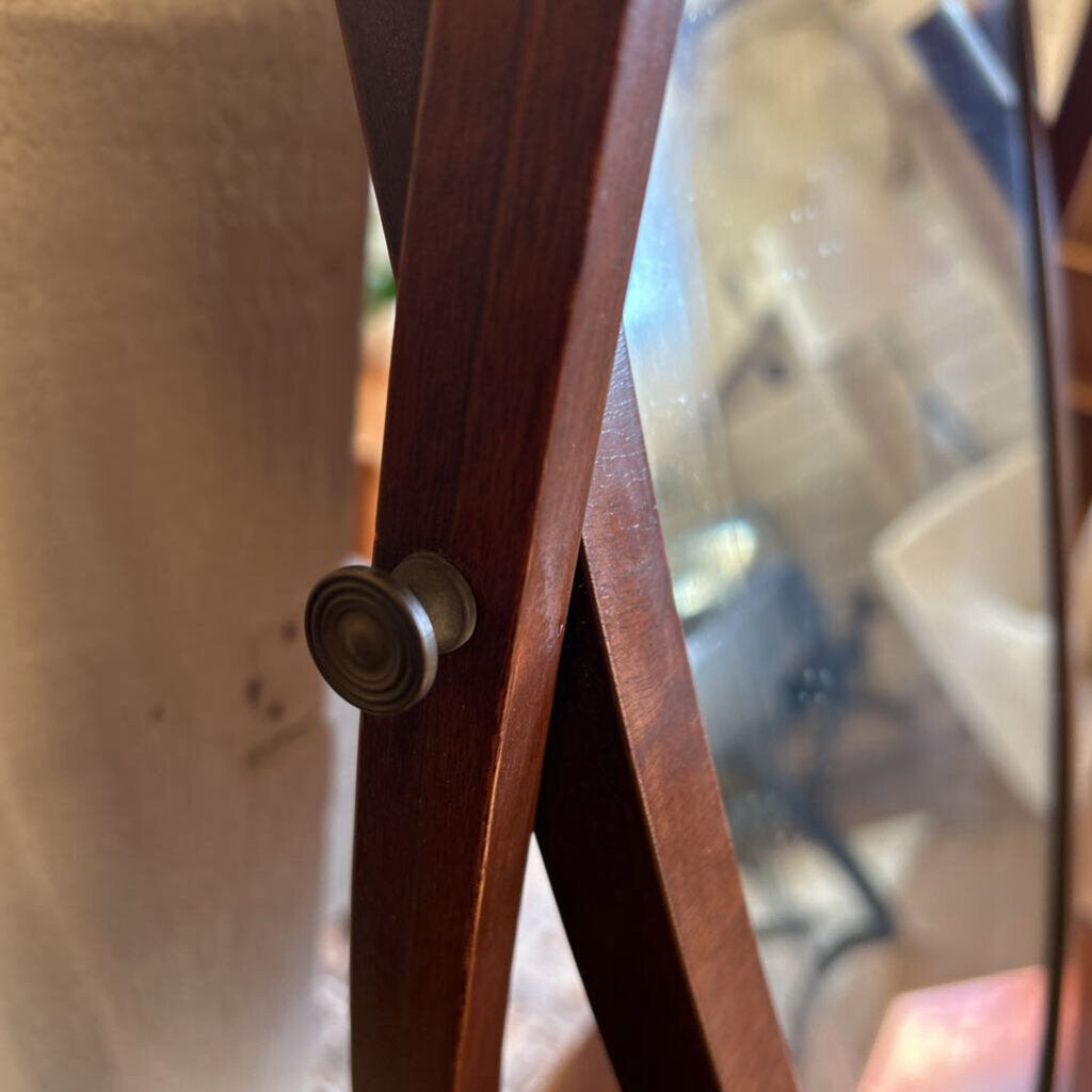 Wooden stand with a round metal knob on a blurred background