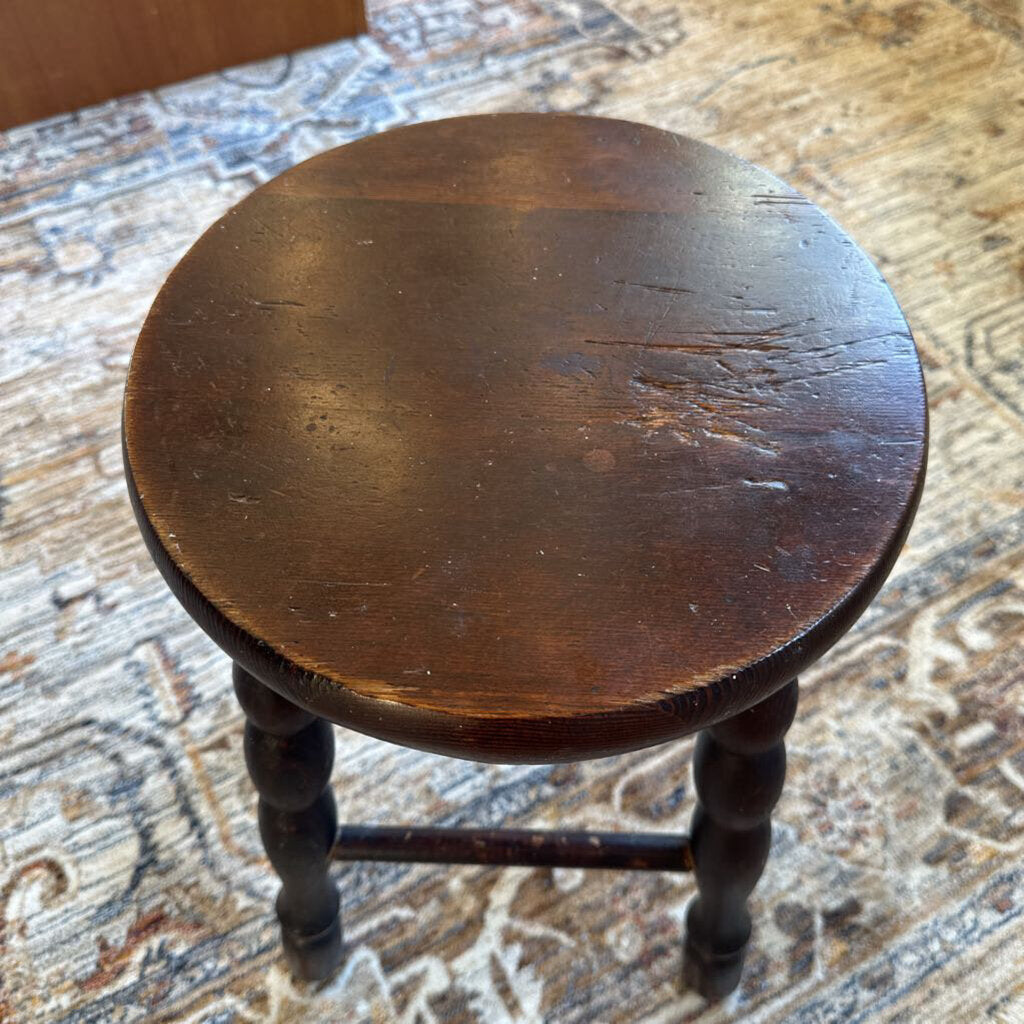 Wooden stool on a textured rug