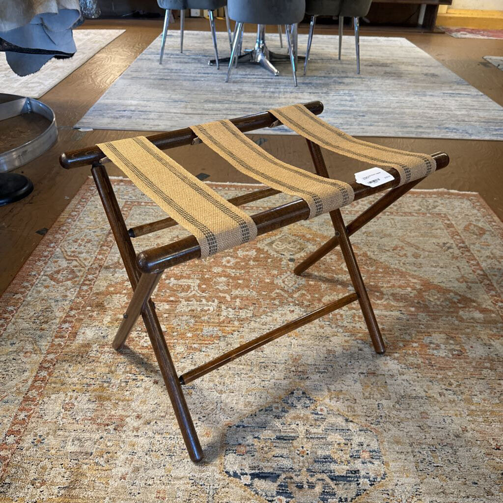 Wooden stool with woven seat on a patterned rug
