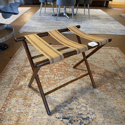 Wooden stool with woven seat on a patterned rug
