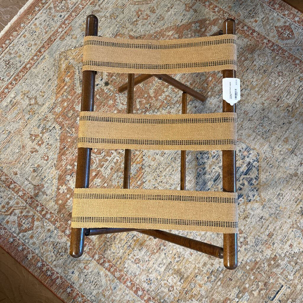 Small wooden chair with woven seat on a patterned floor