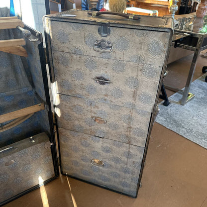 Vintage-style suitcase with floral pattern on a wooden floor