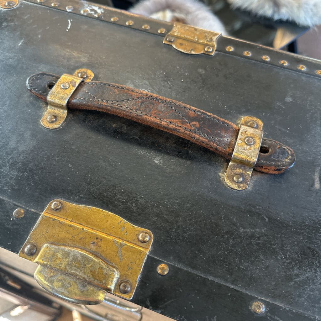 Vintage suitcase with a rusty handle and brass hardware