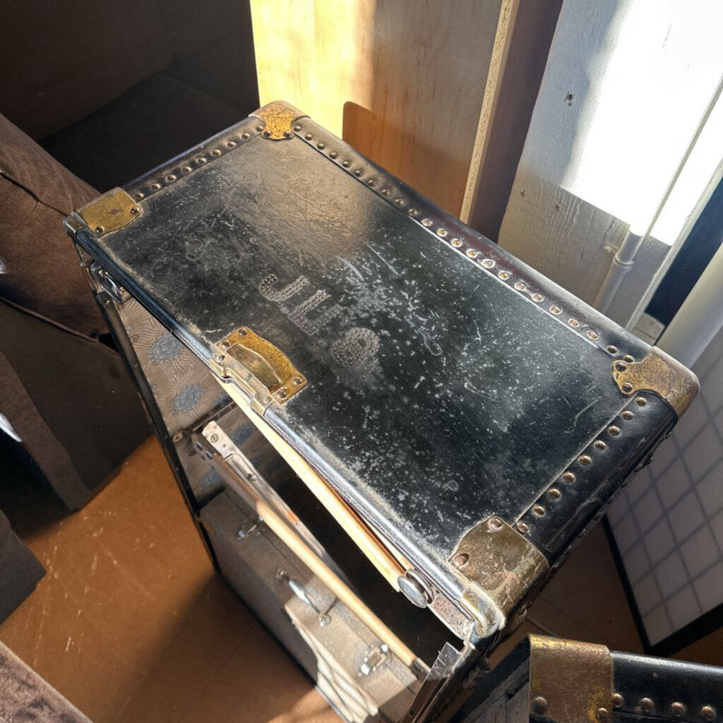 Vintage suitcase with gold accents on a wooden surface