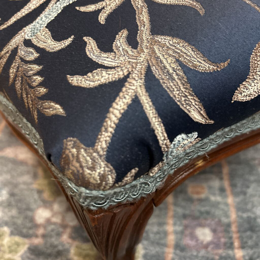 Decorative cushion with gold embroidery on a dark background