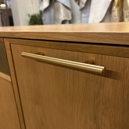 Wooden cabinet with a gold handle in an indoor setting