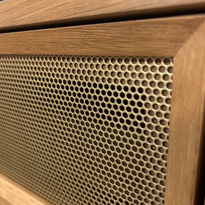 Wooden speaker with honeycomb pattern on grille