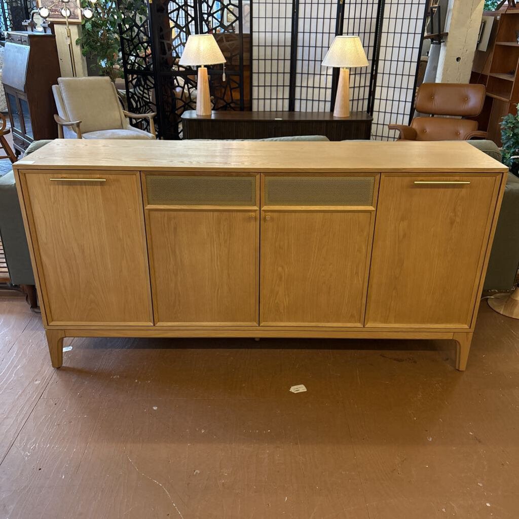 Wooden sideboard in a room with chairs and lamps